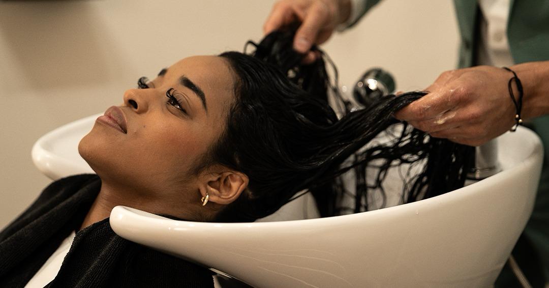 Girl getting her hair washed in Adrian's salon.